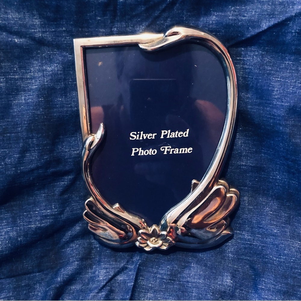 Elegant Silver Plated Frame with beautiful swans encasing it.
